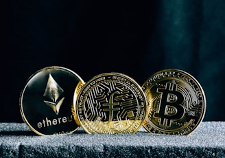 three bitcoins sitting on top of a table