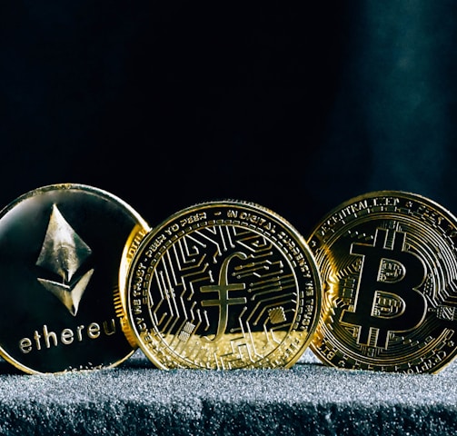 three bitcoins sitting on top of a table