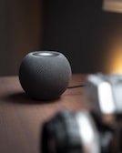 a speaker sitting on top of a wooden table