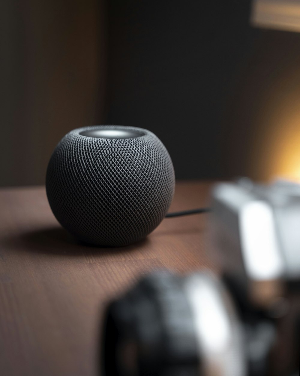 a speaker sitting on top of a wooden table