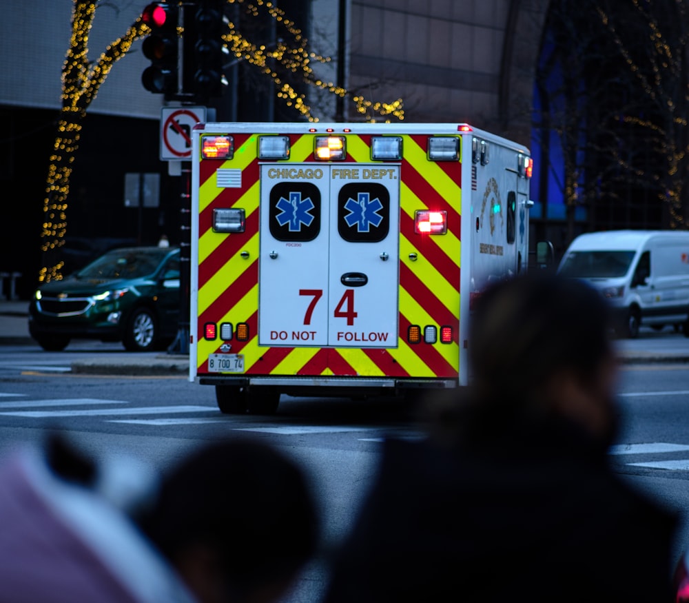 an ambulance driving down a city street at night