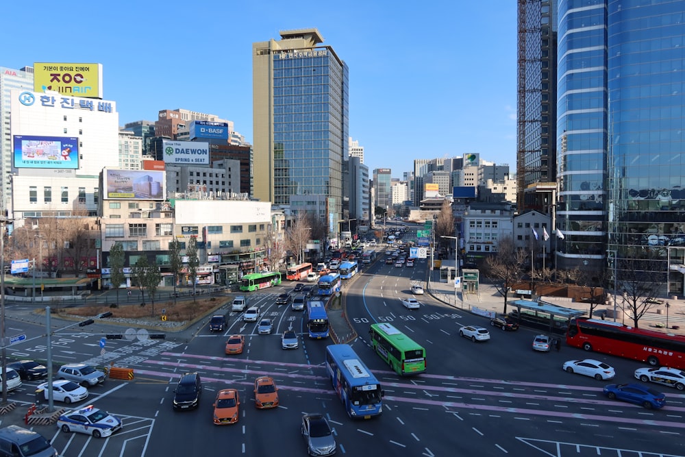 a city street filled with lots of traffic next to tall buildings