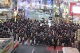 A bustling city street filled with people and lights.