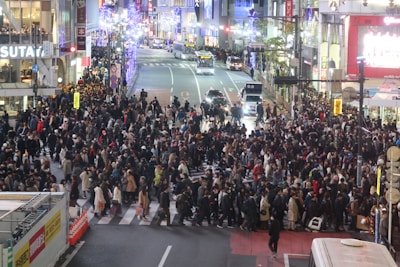 A bustling city street filled with people and lights.