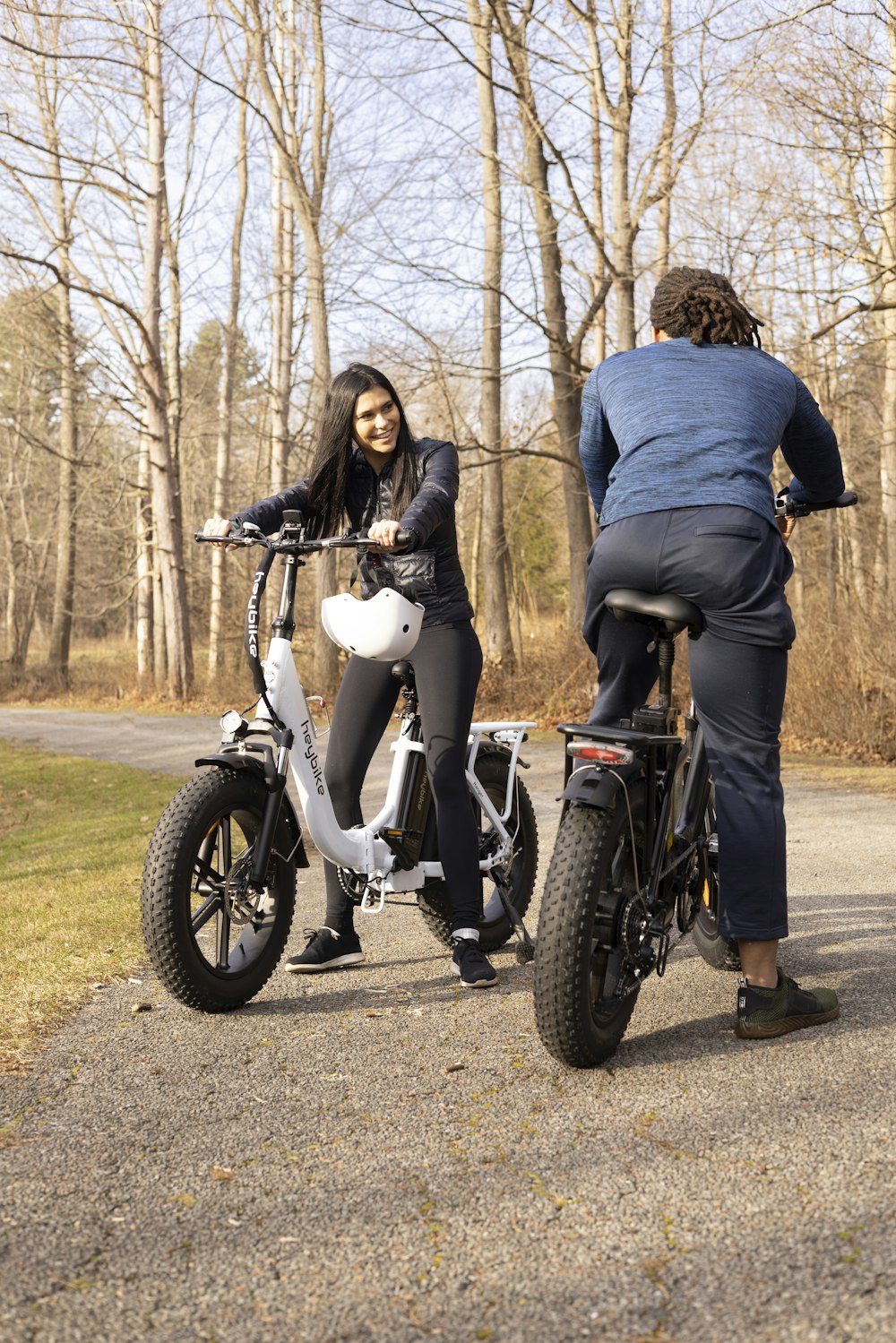 a man and a woman riding bikes on a road