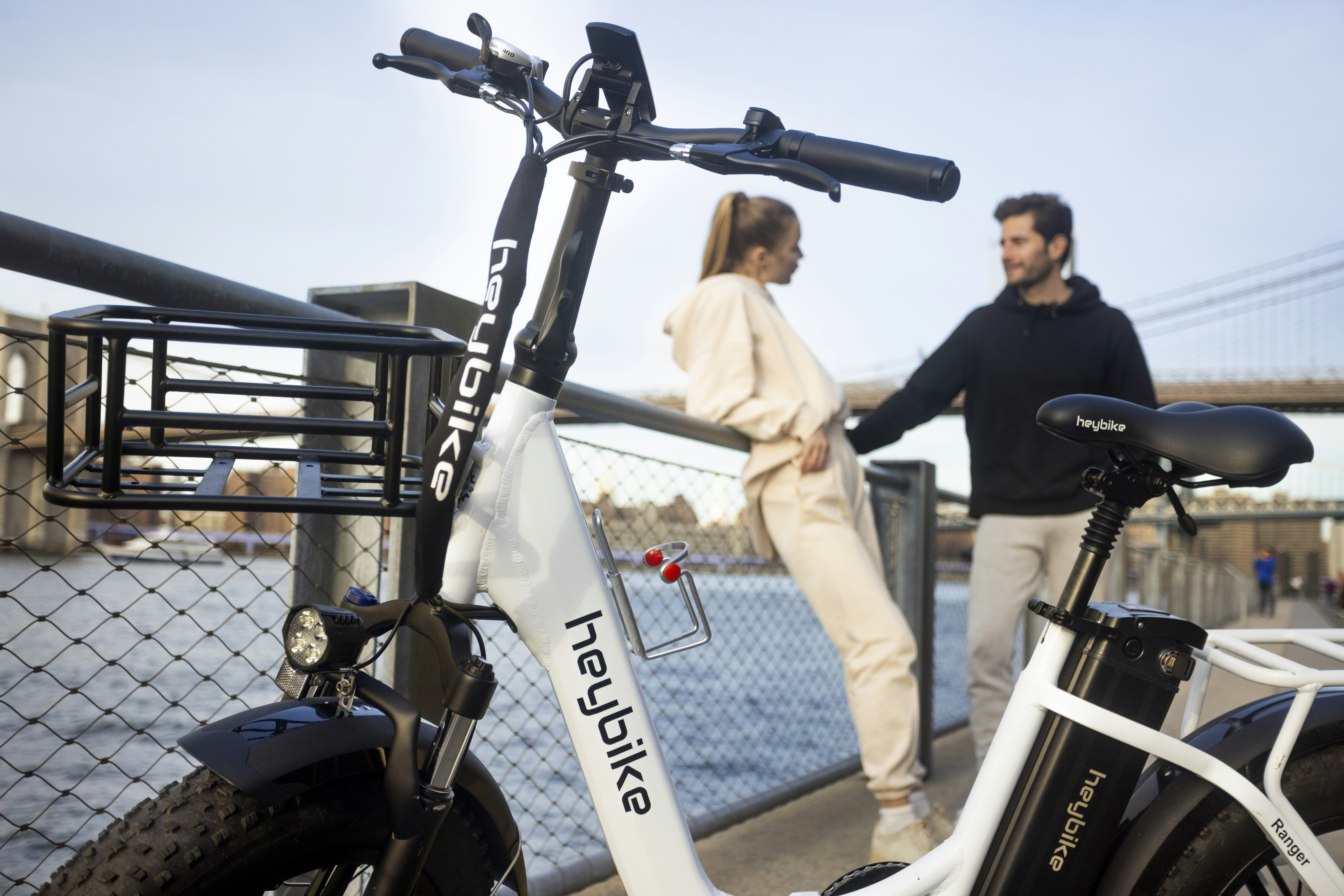 a man and a woman standing next to a bike