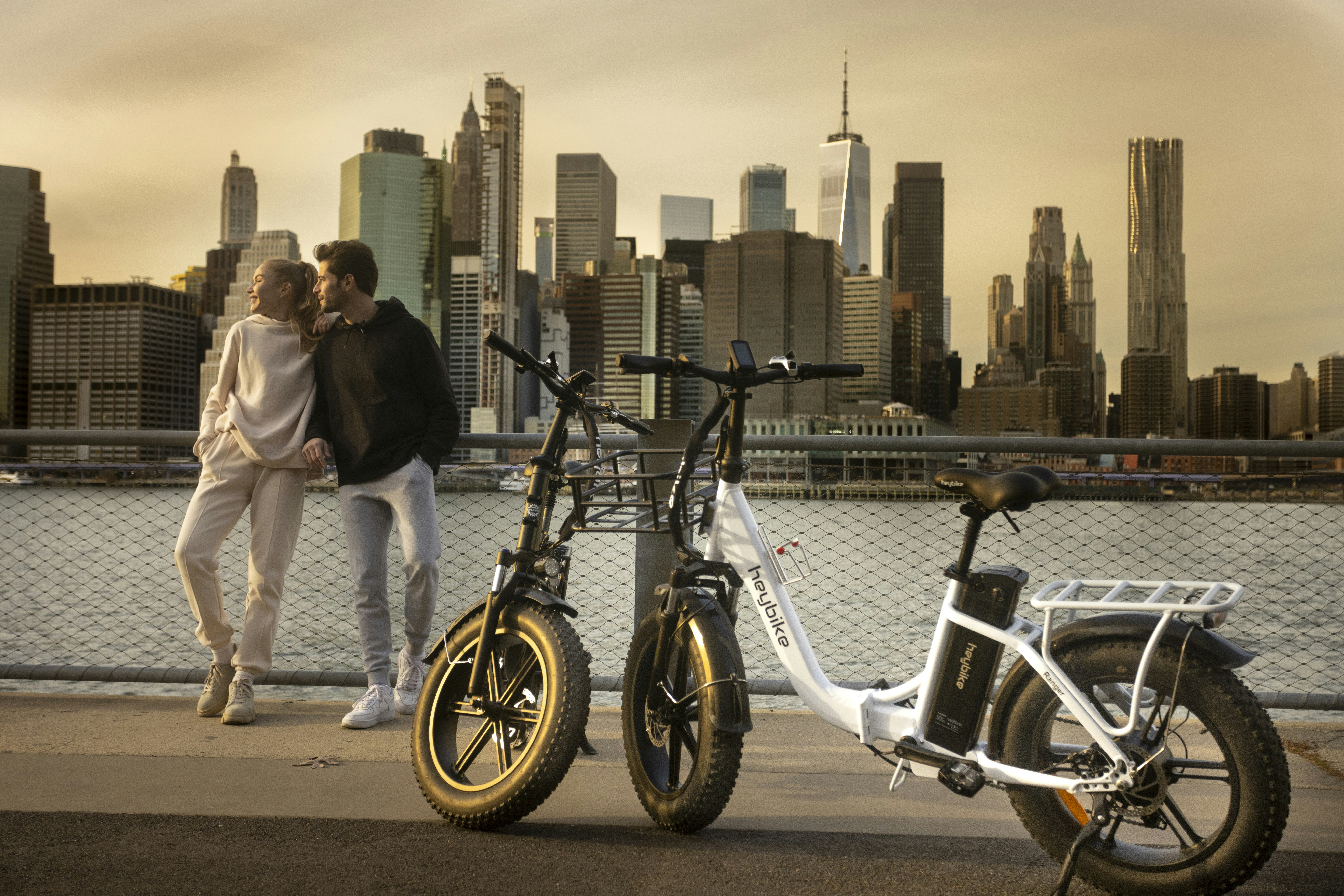a man and a woman standing next to a bike