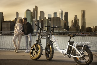 a man and a woman standing next to a bike