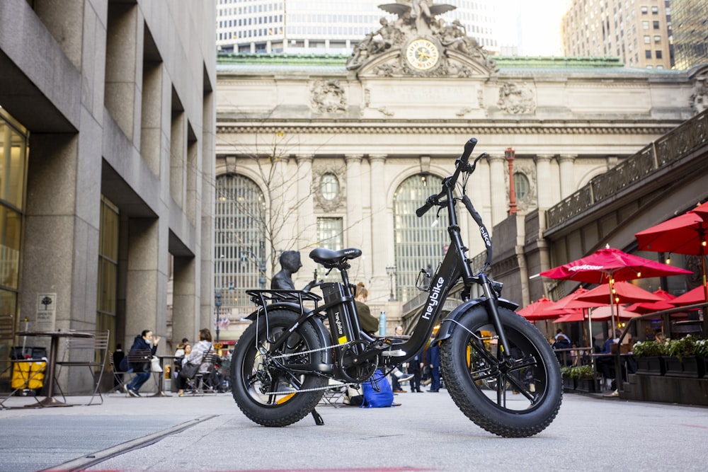 two bikes parked next to each other in front of a building