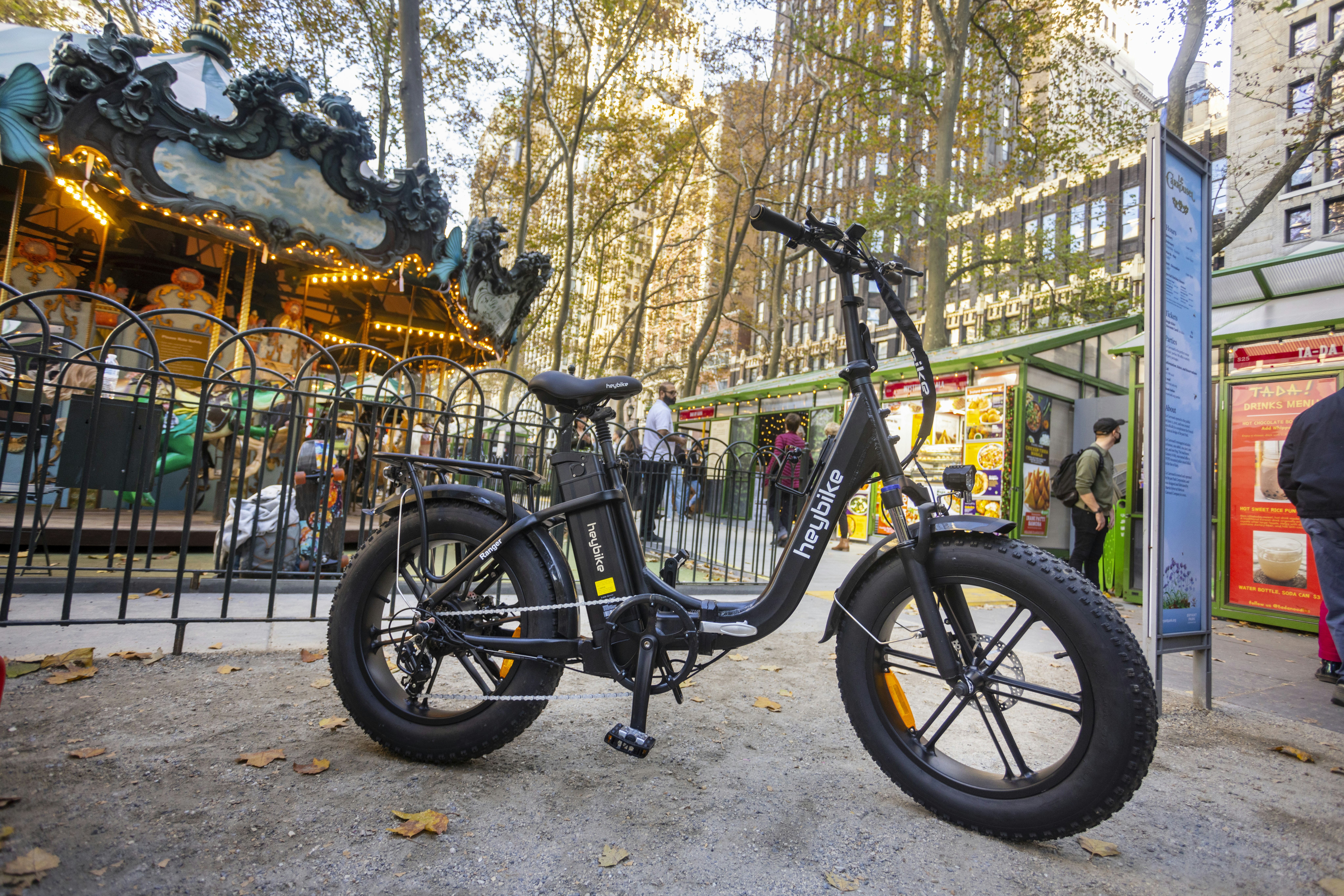 an electric bike parked in front of a carousel