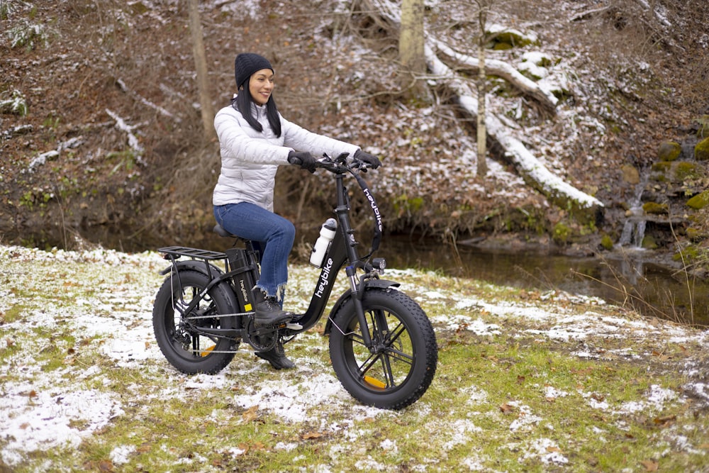 a woman is riding a bike in the snow