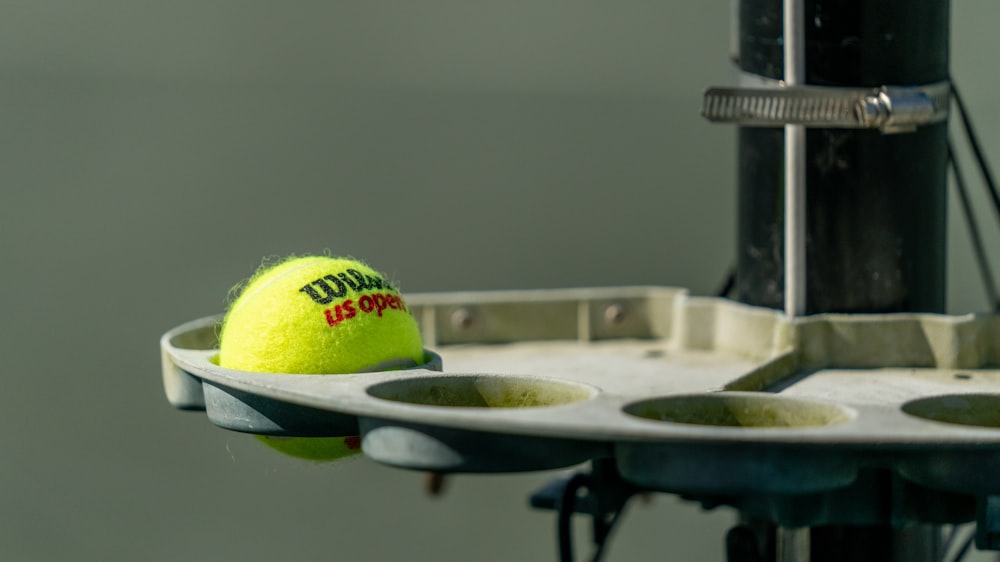 a tennis ball sitting on top of a rack