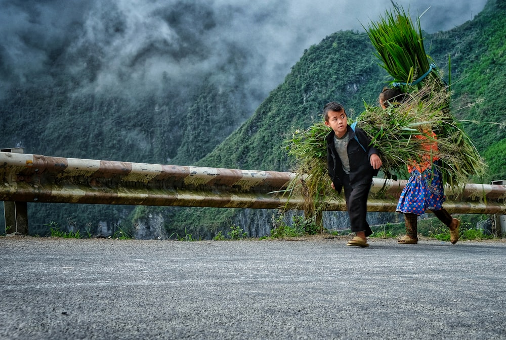 a couple of people that are walking down a road