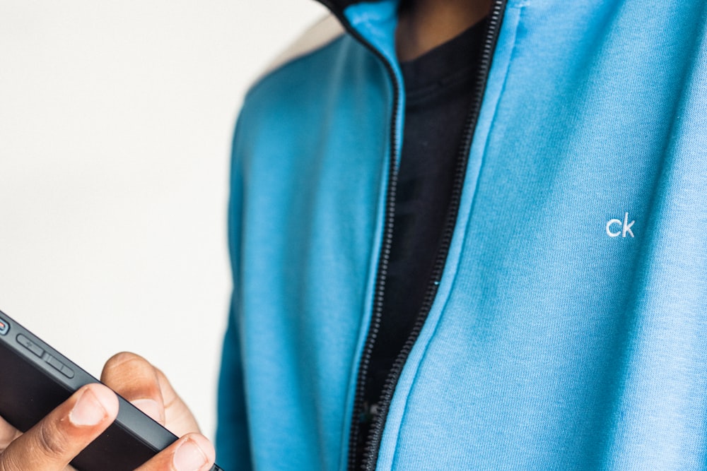 a person holding a remote control in their hand