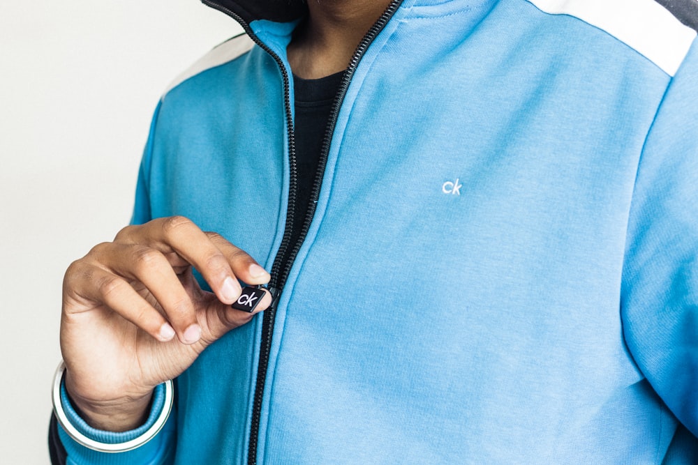 a close up of a person wearing a blue jacket
