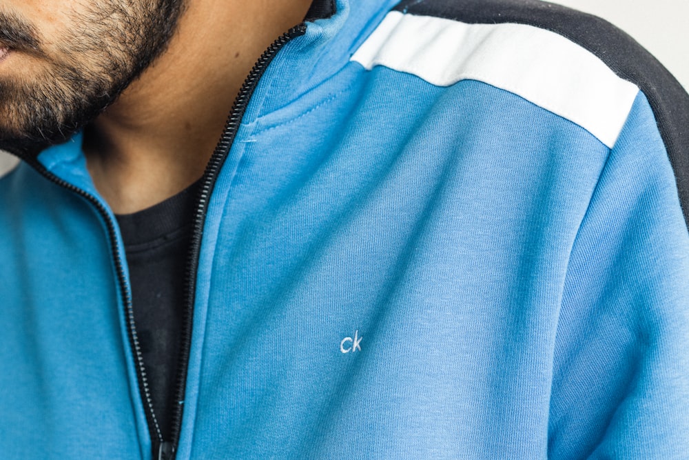 a close up of a person wearing a blue jacket