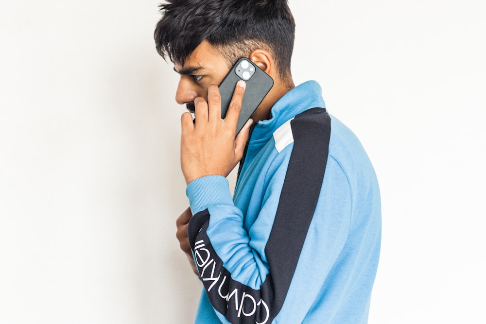 a young man talking on a cell phone