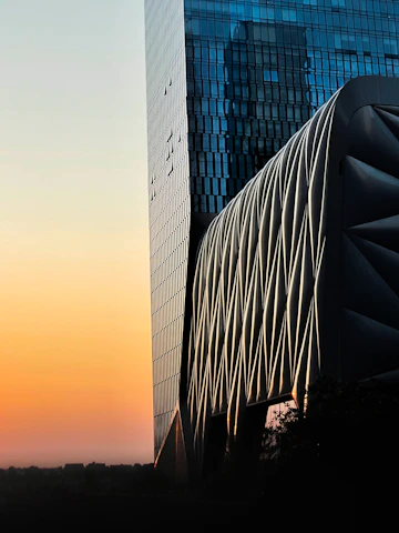 Exterior view of a sleek, contemporary infrastructure project at sunset.