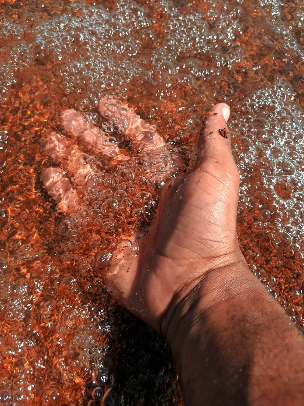 a person's foot in a puddle of water