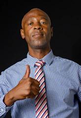 A confident businessman presenting a large check with a determined expression in an office setting