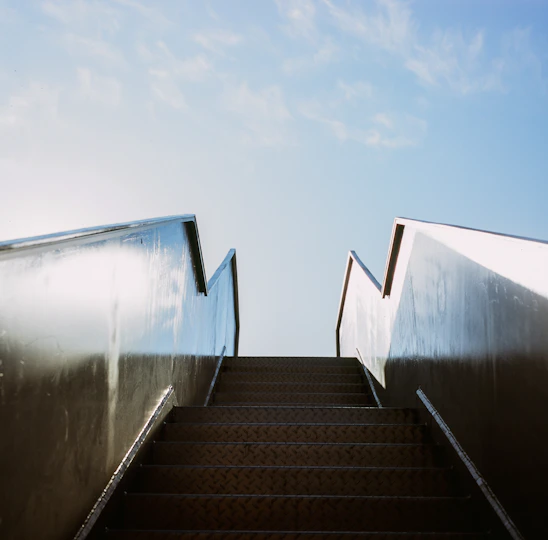 Elegant golden staircase ascending into a bright, hopeful sky symbolizing growth in true love.