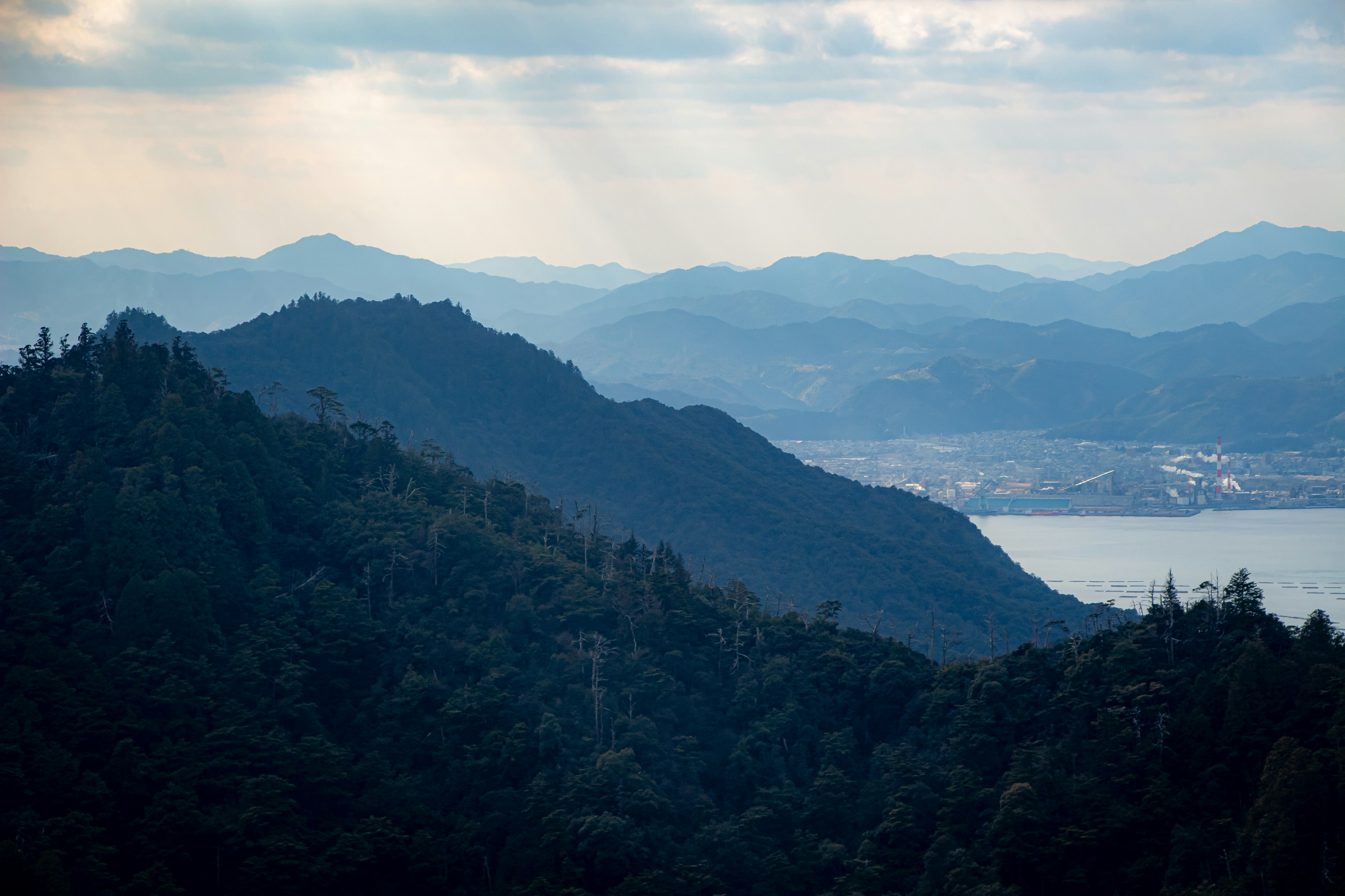 a view of a mountain range with a body of water in the distance