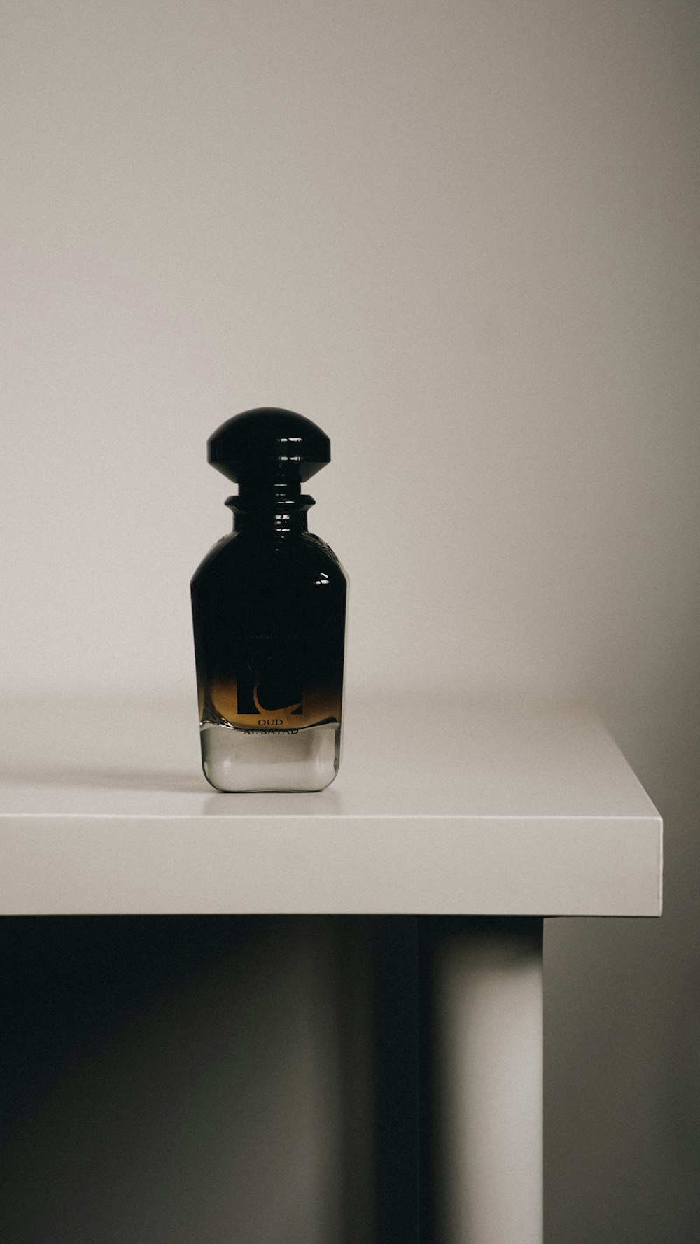 a bottle sitting on top of a white table