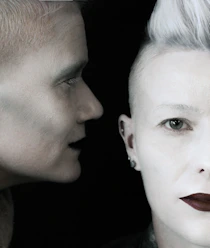 a man and a woman with white hair