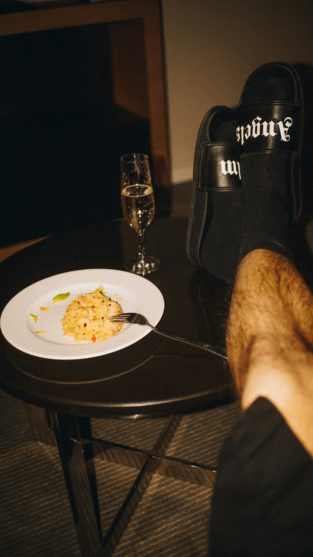 a person sitting at a table with a plate of food