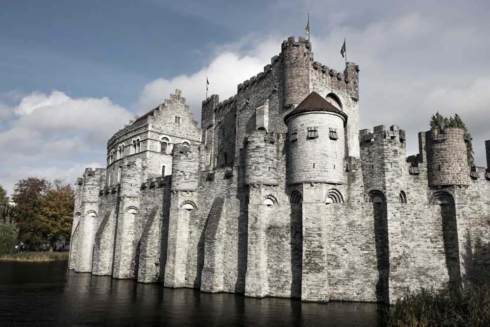 a large castle like structure with a moat in front of it