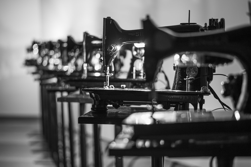 a row of sewing machines sitting on top of a table