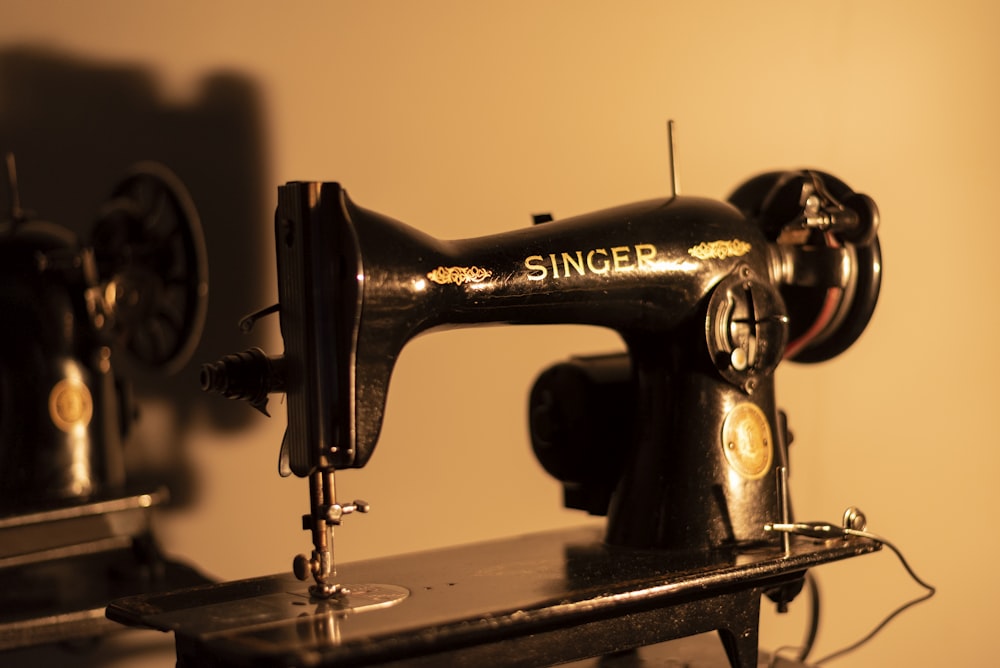 a black sewing machine sitting on top of a table