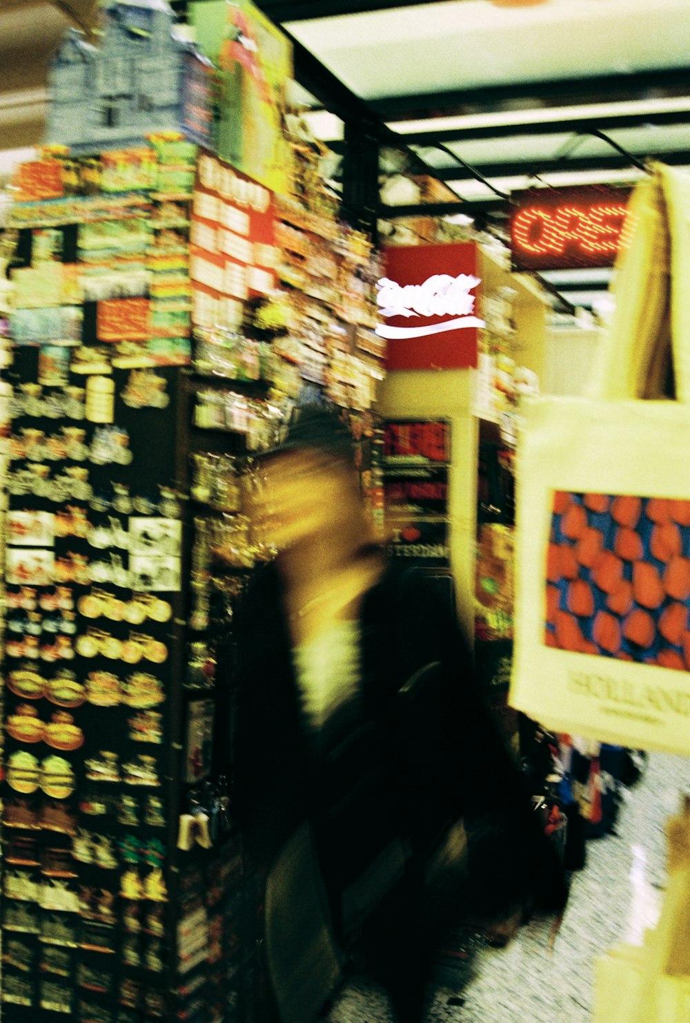 a person walking through a store filled with lots of items