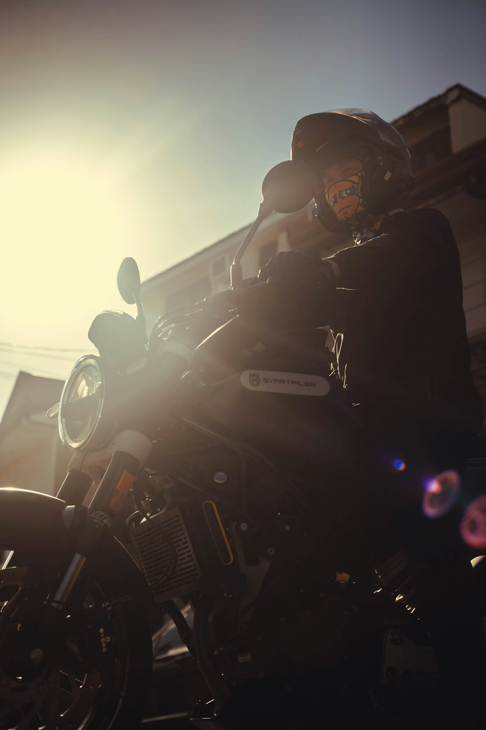 a person sitting on a motorcycle in the sun