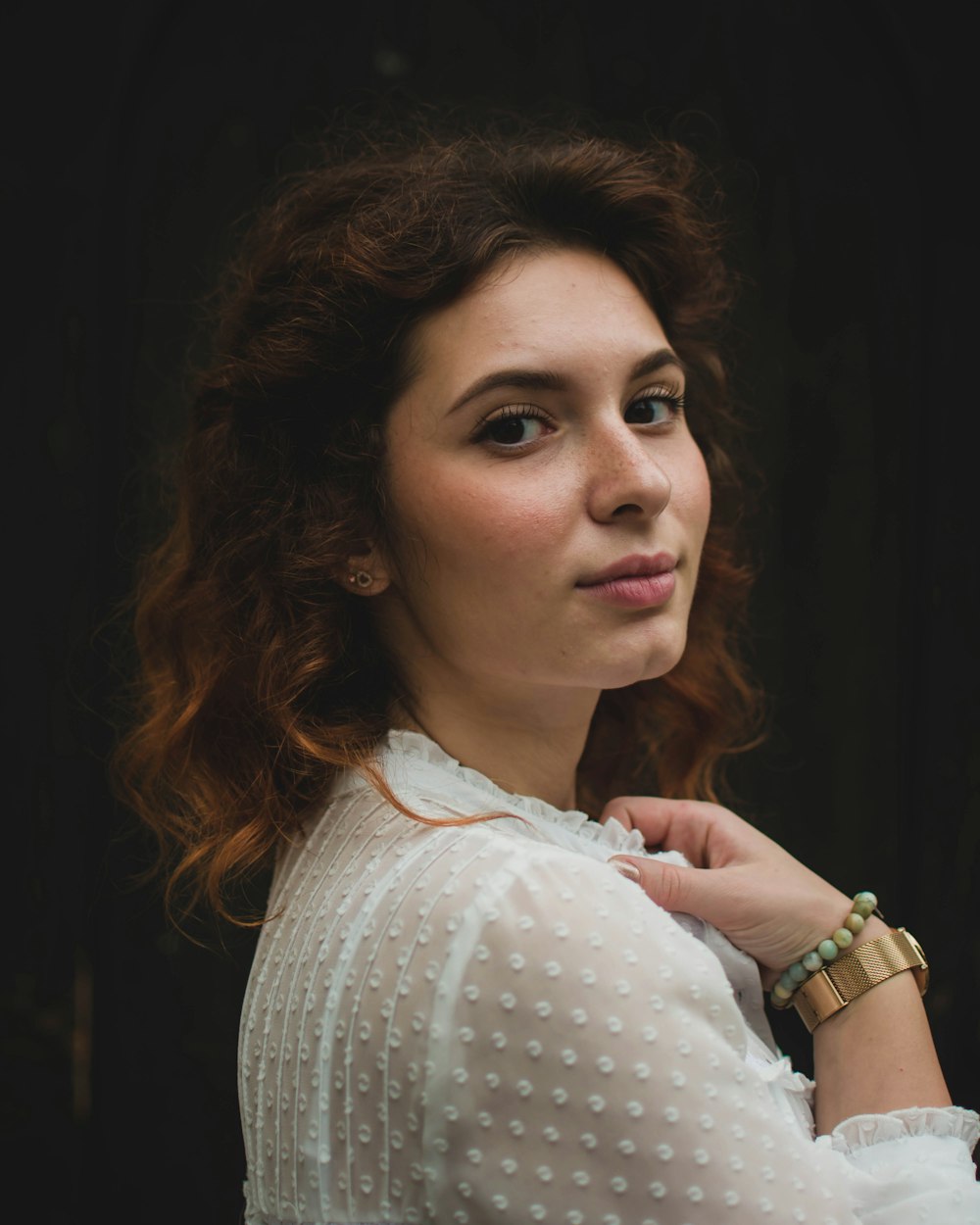 a woman in a white shirt is posing for a picture