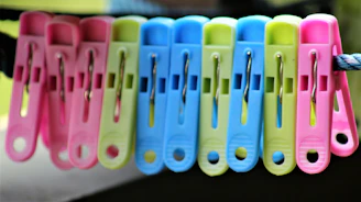 Finished batch of colorful aprons hanging in a neat row.
