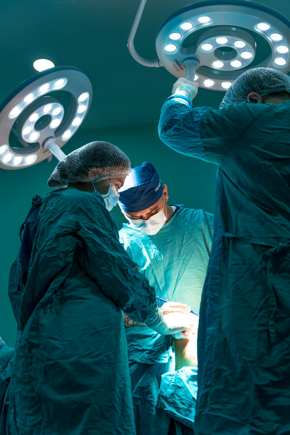 a group of doctors performing surgery on a patient