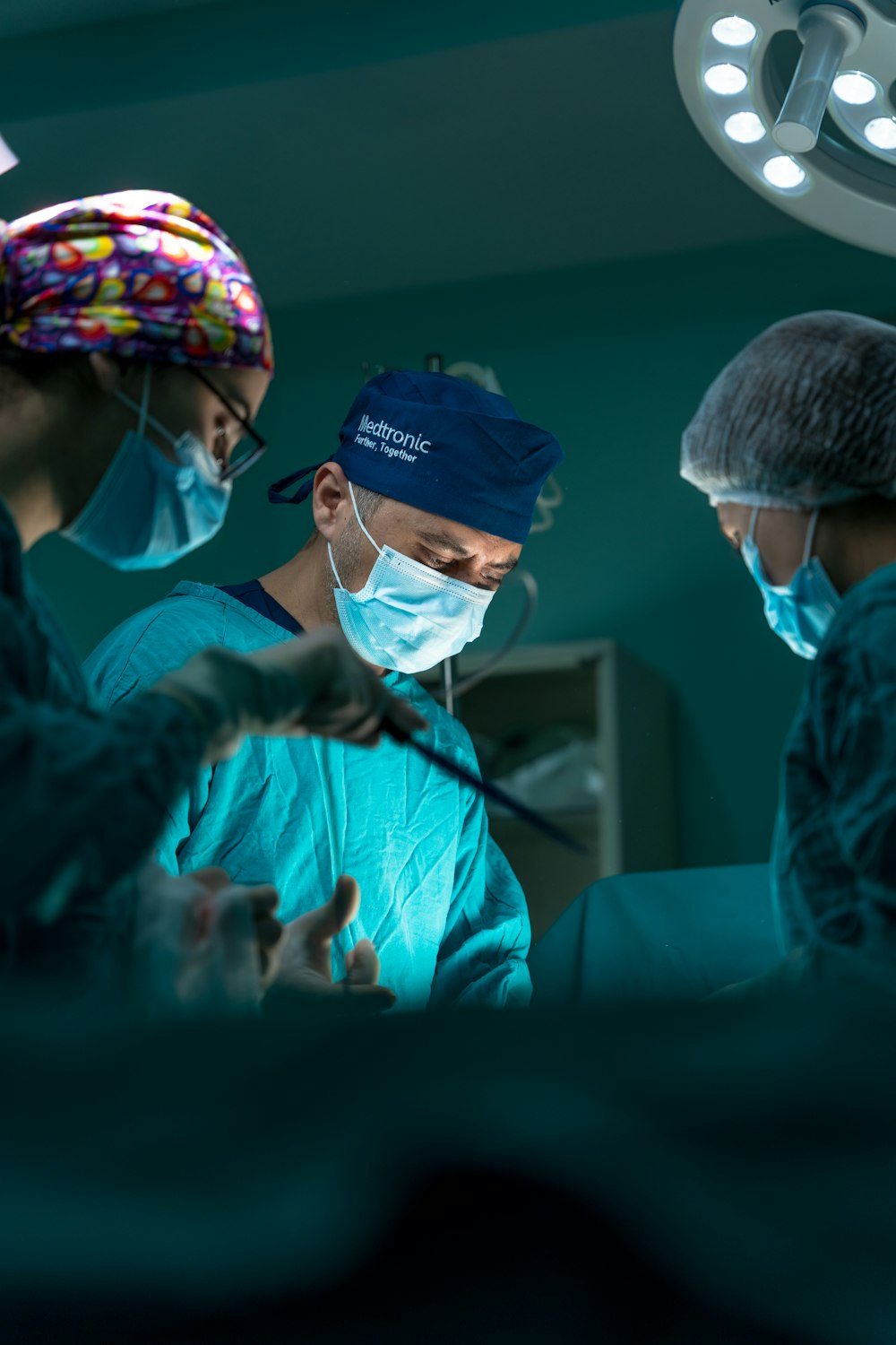 a group of doctors performing surgery in an operating room