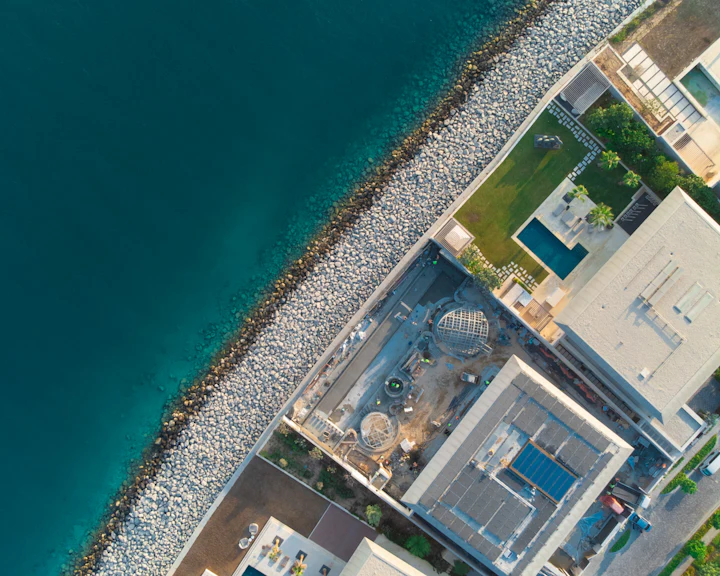 Aerial view of a waterfront residential shoreline with beach frontage