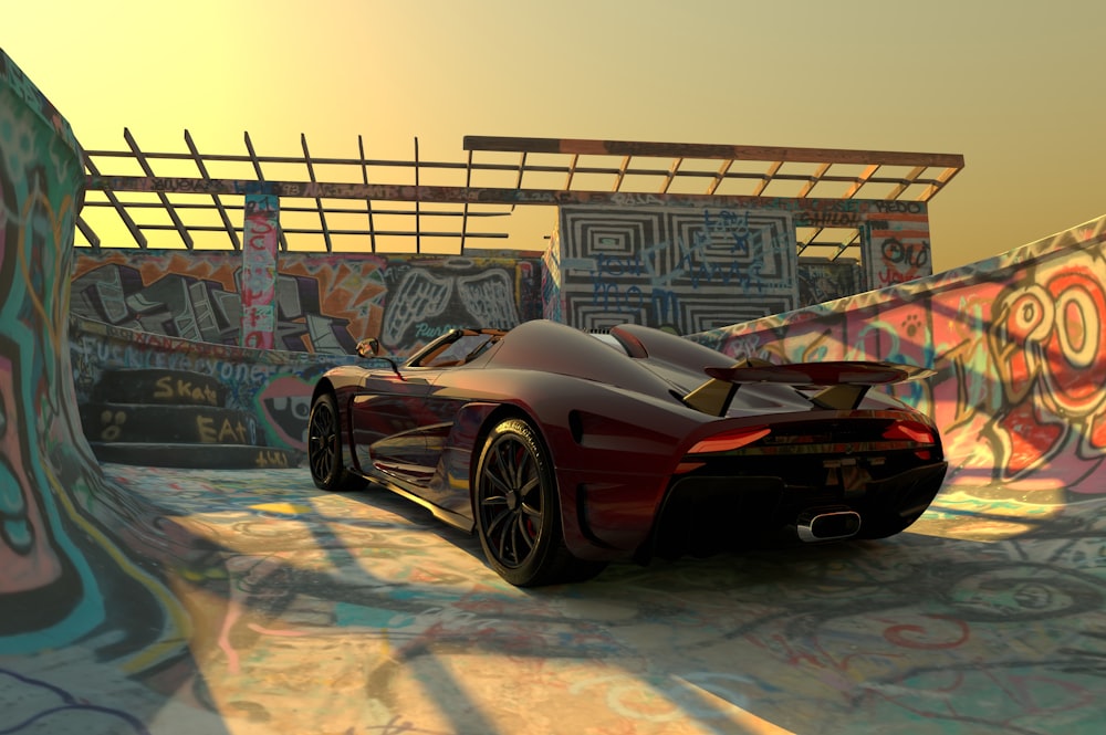 a red sports car parked in front of a graffiti covered wall