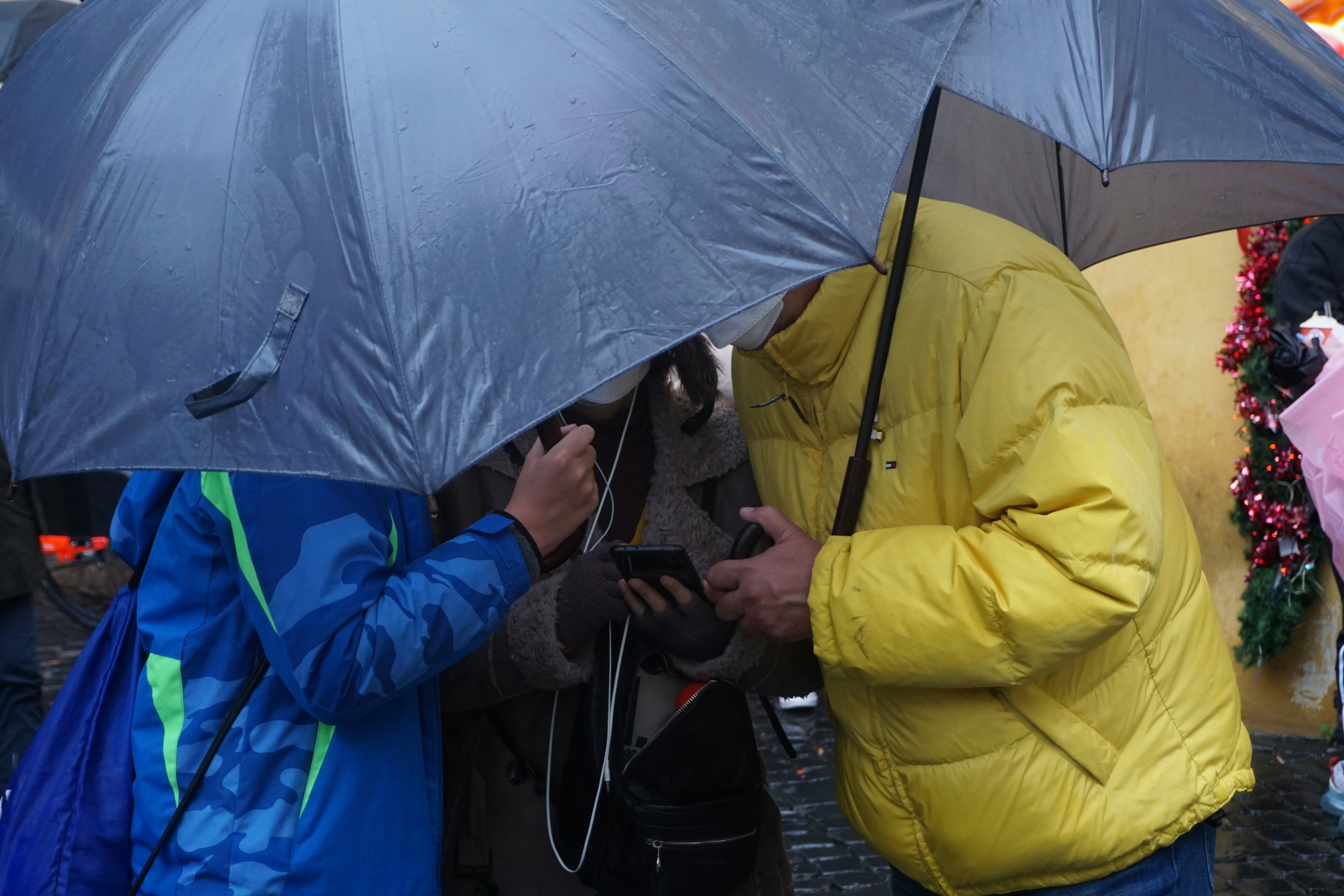 a couple of people standing under an umbrella