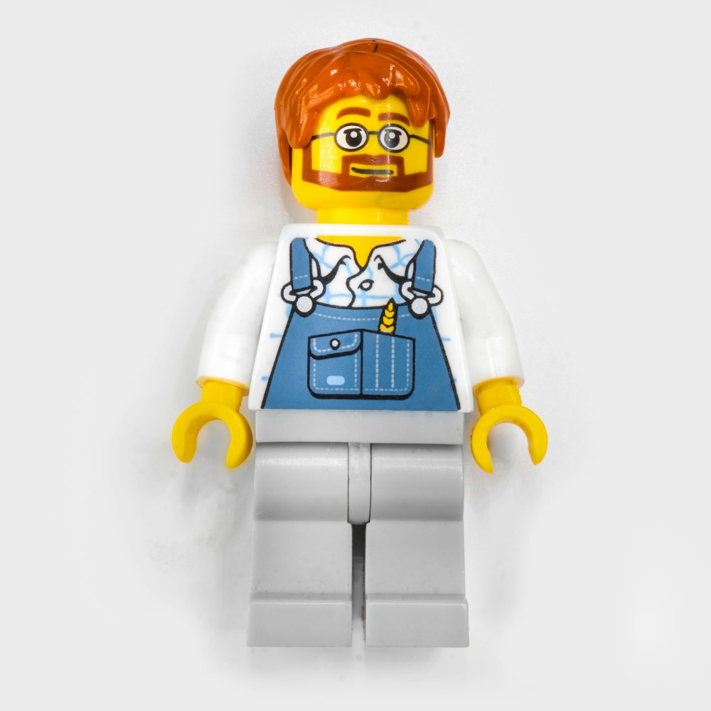 a lego man with a red hair and glasses