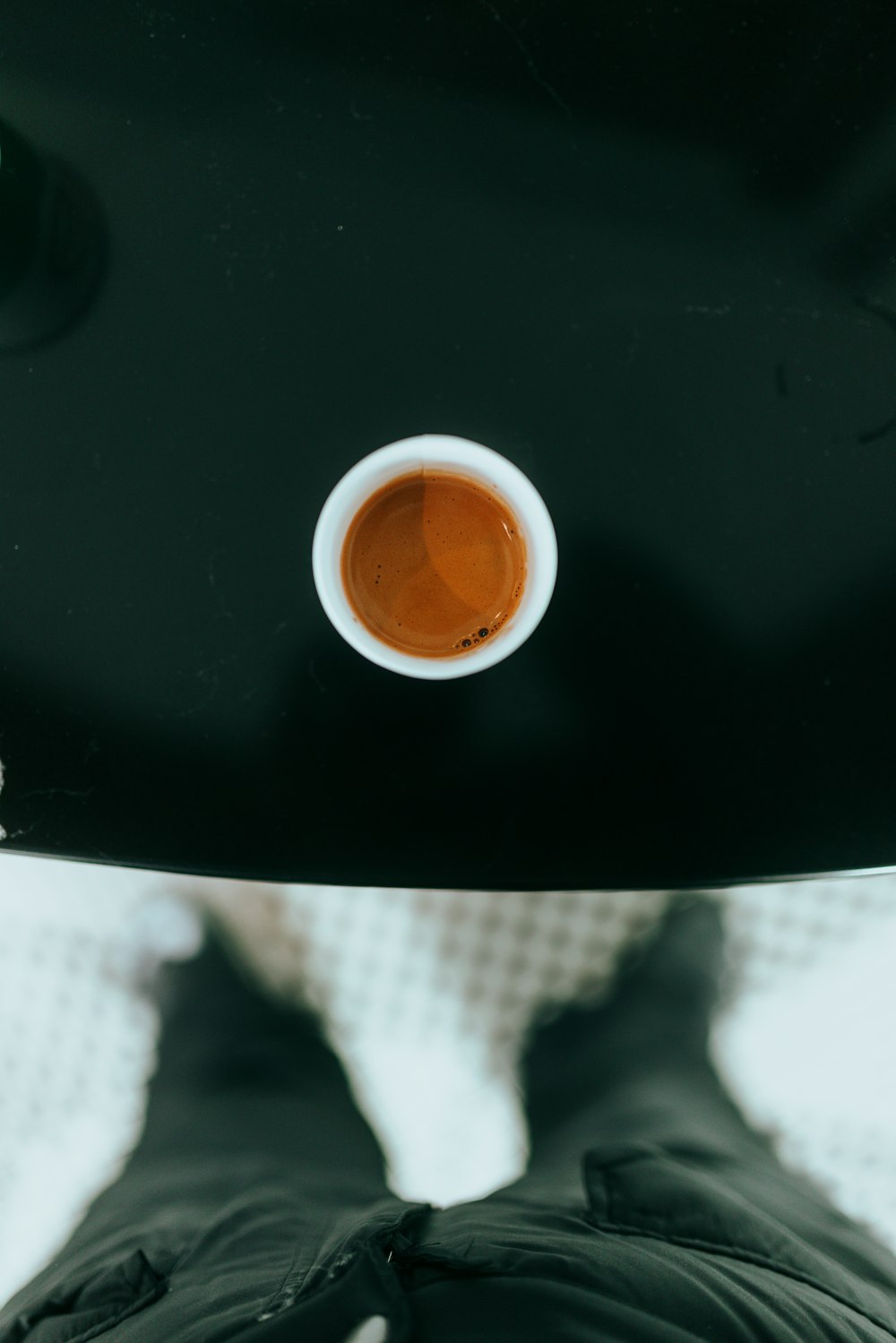 a person's shadow with a cup of tea in their hand