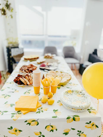 The lemon + bees team warmly serving guests at a lively bachelorette party with chic decor.