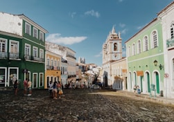 a cobblestone street lined with colorful buildings