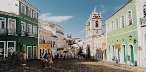 a cobblestone street lined with colorful buildings