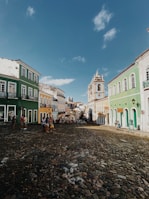 a cobblestone street lined with colorful buildings