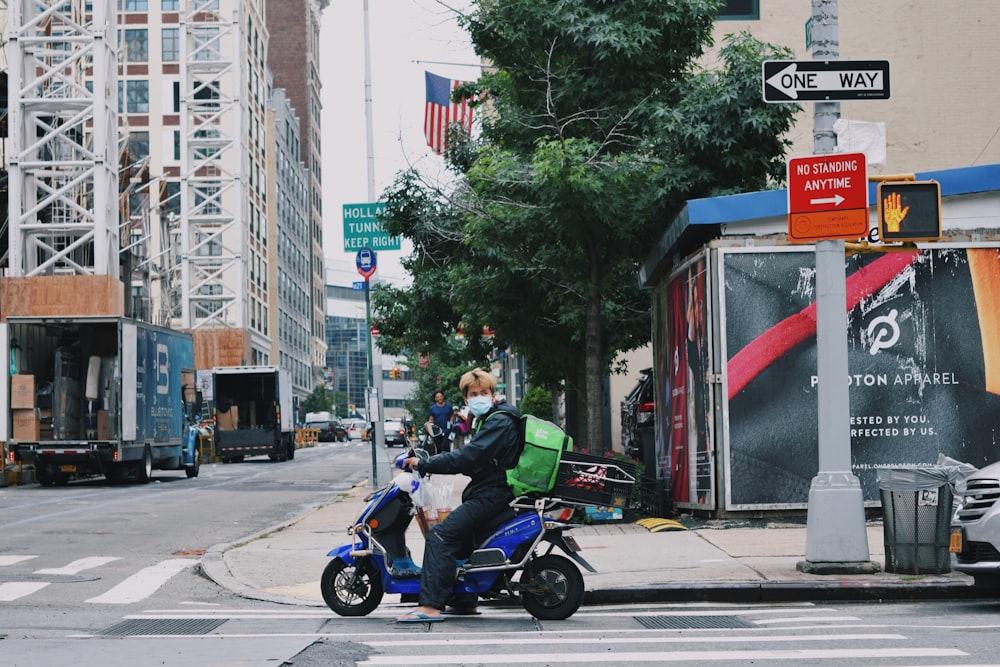 a man riding a scooter on a city street