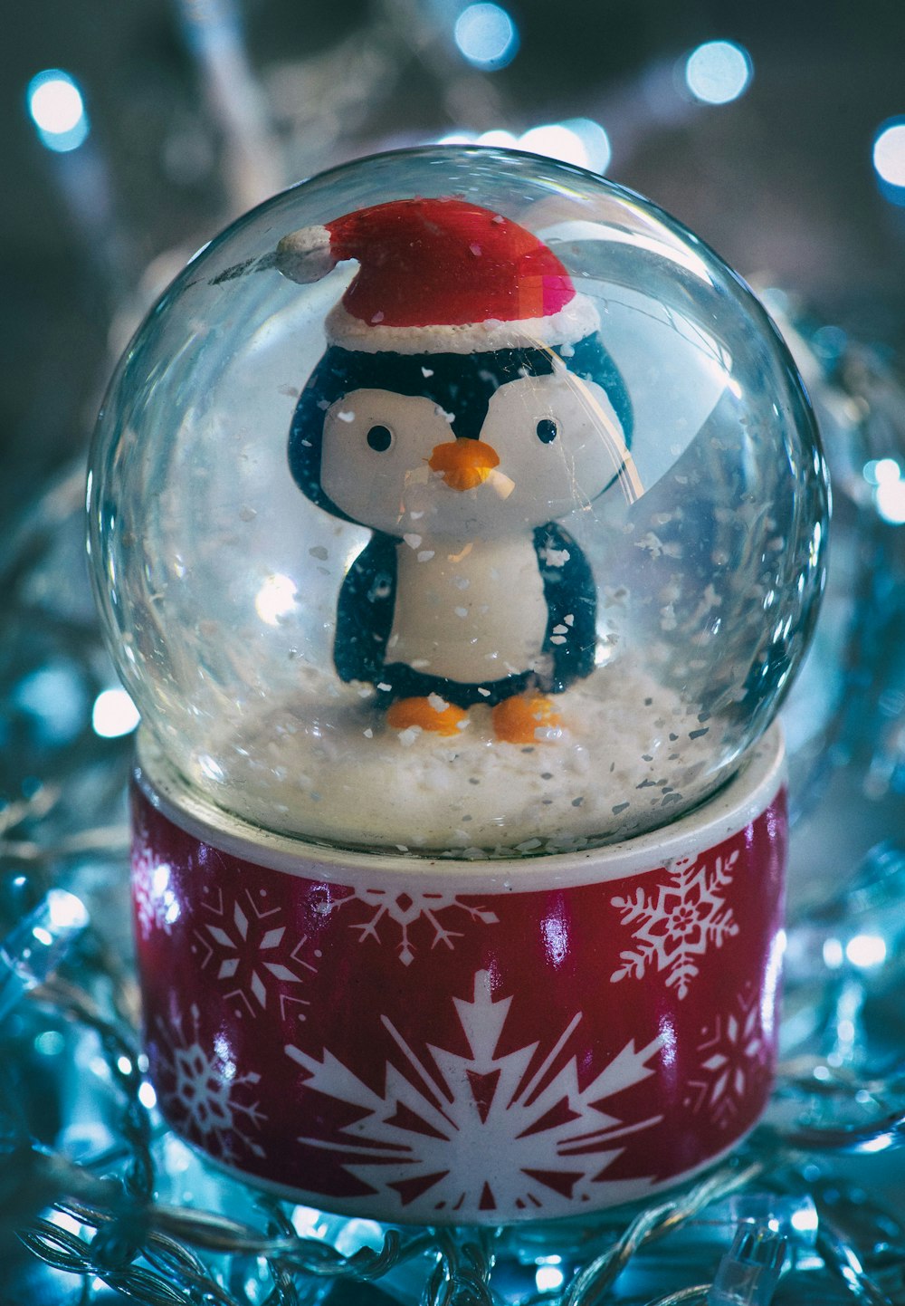 a snow globe with a penguin inside of it