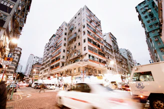 Timelapse of a busy urban neighborhood highlighting different property fronts.